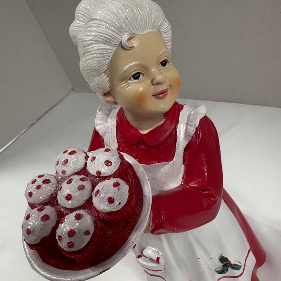 Mrs Claus figurine holding a tray of red cupcakes. - Picture 2 of 7